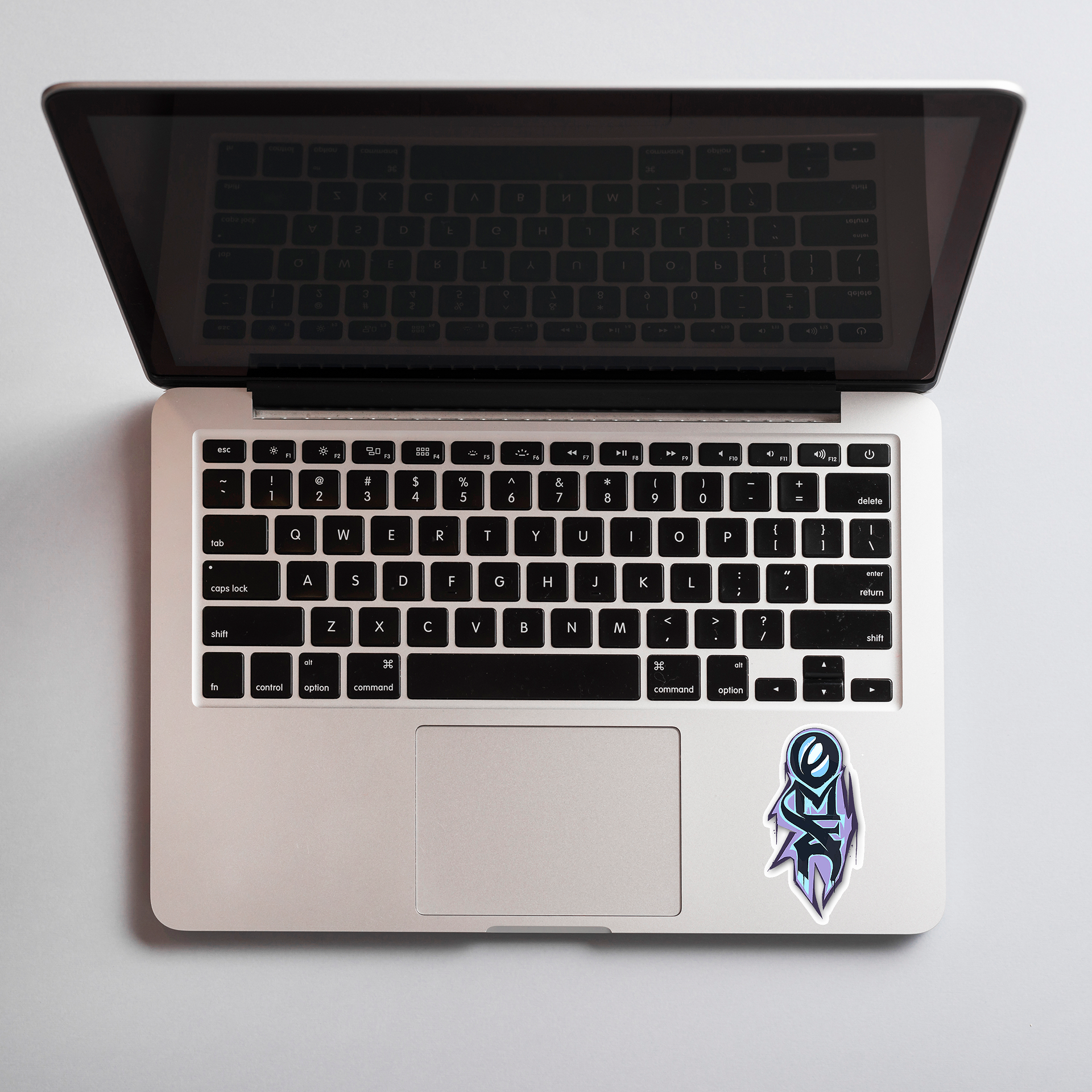 Laptop with a omen sticker on the palm rest area on a light gray background